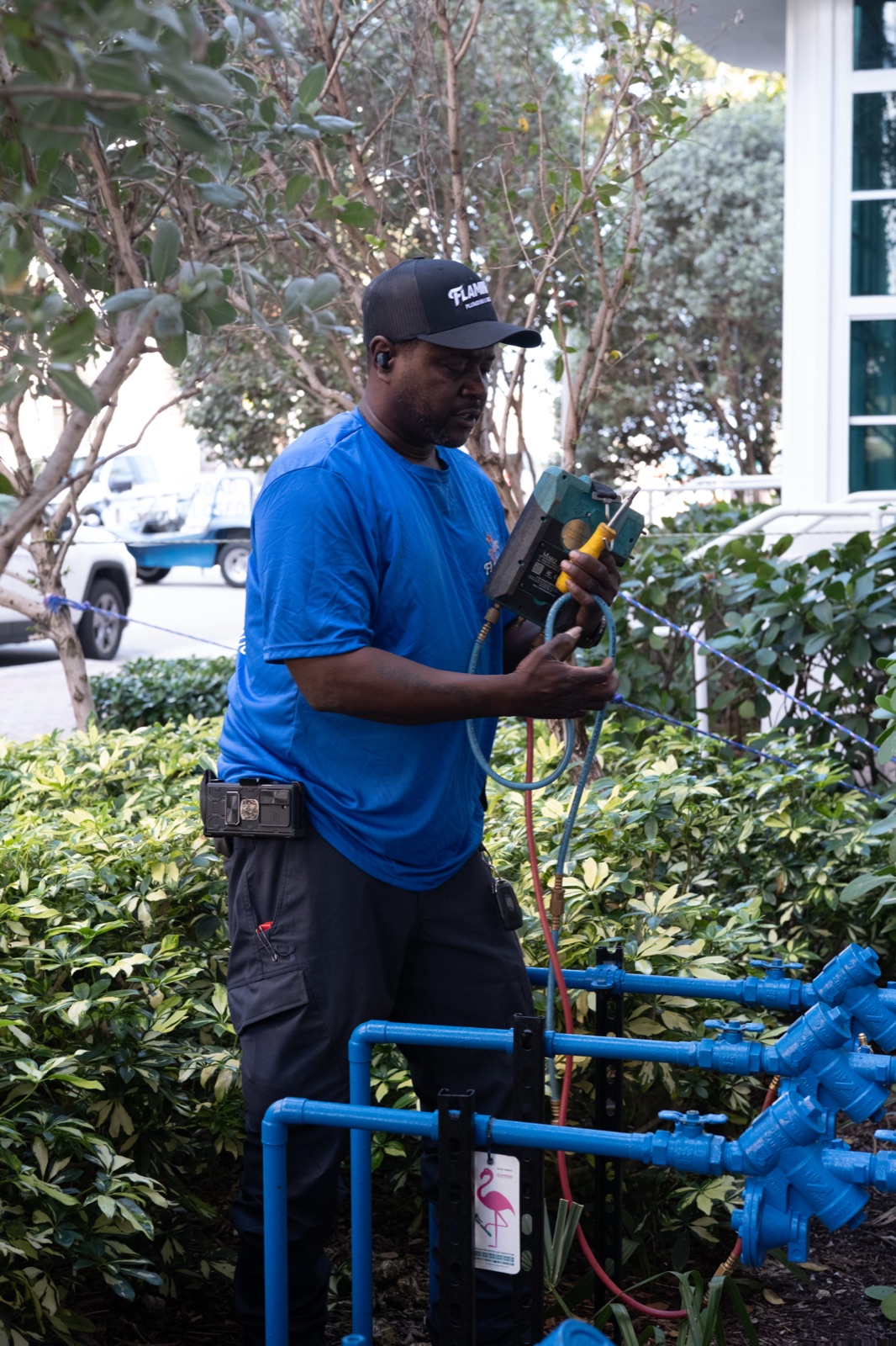 Flamingo technician servicing a backflow preventer assembly in the field