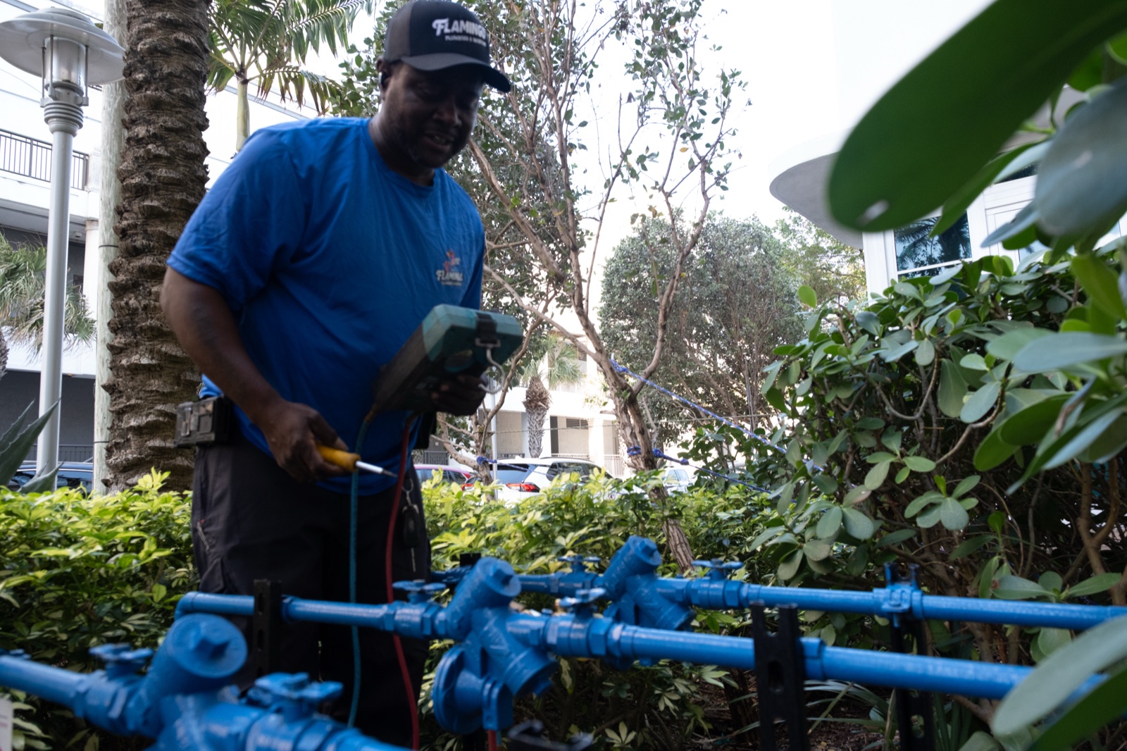 A technician connecting gauges to a backflow prevention device