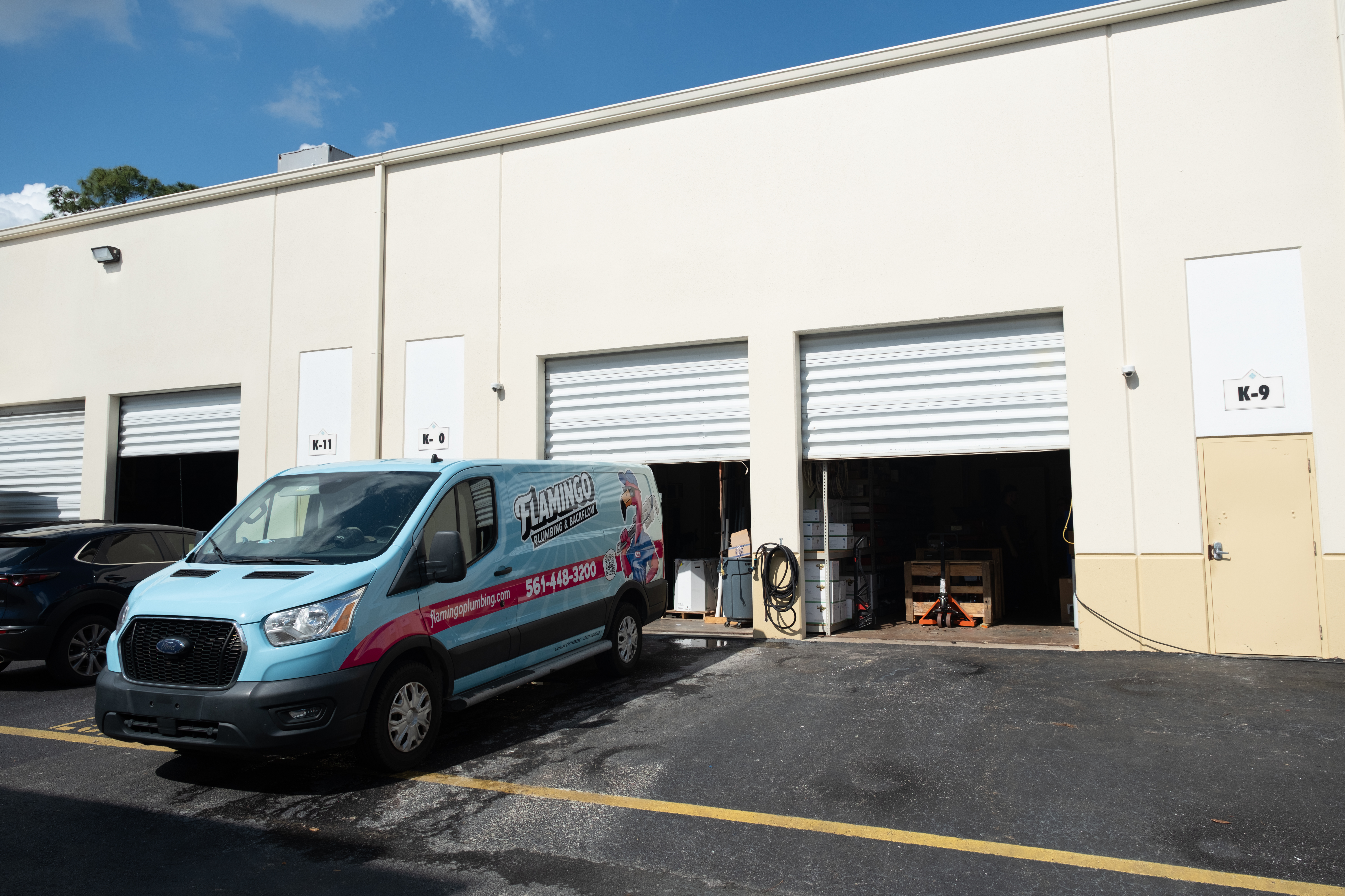 A Flamingo Plumbing truck parked at the warehouse